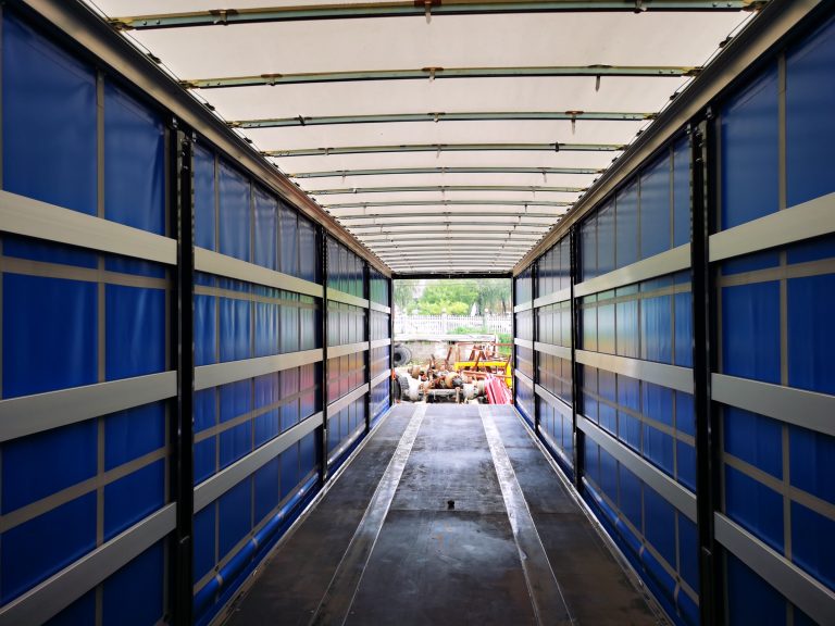 How does the lightweight design of curtain-sided trailers impact fuel efficiency?